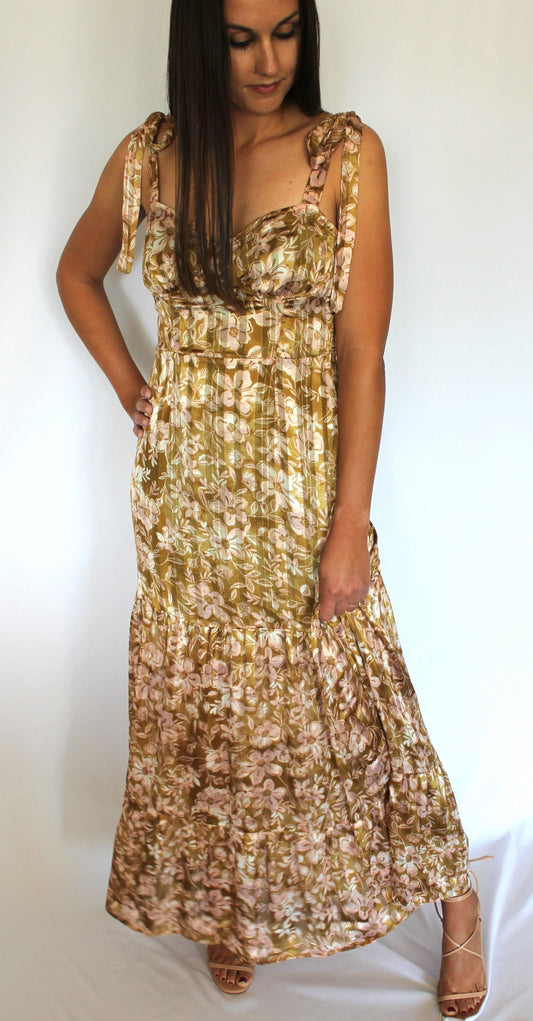 Brunette female wearing olive colored floral print maxi dress